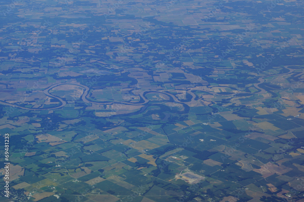 aerial photograph of rural middle USA with river running though