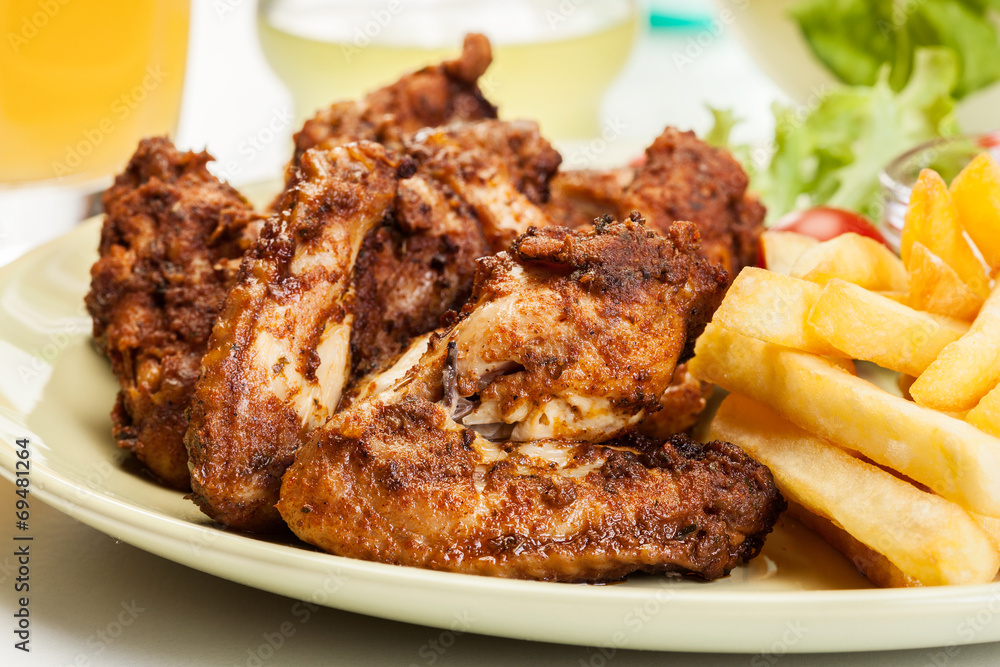 Chicken wings with fries french and spicy sauce Chicken wings with fries french and spicy sauce