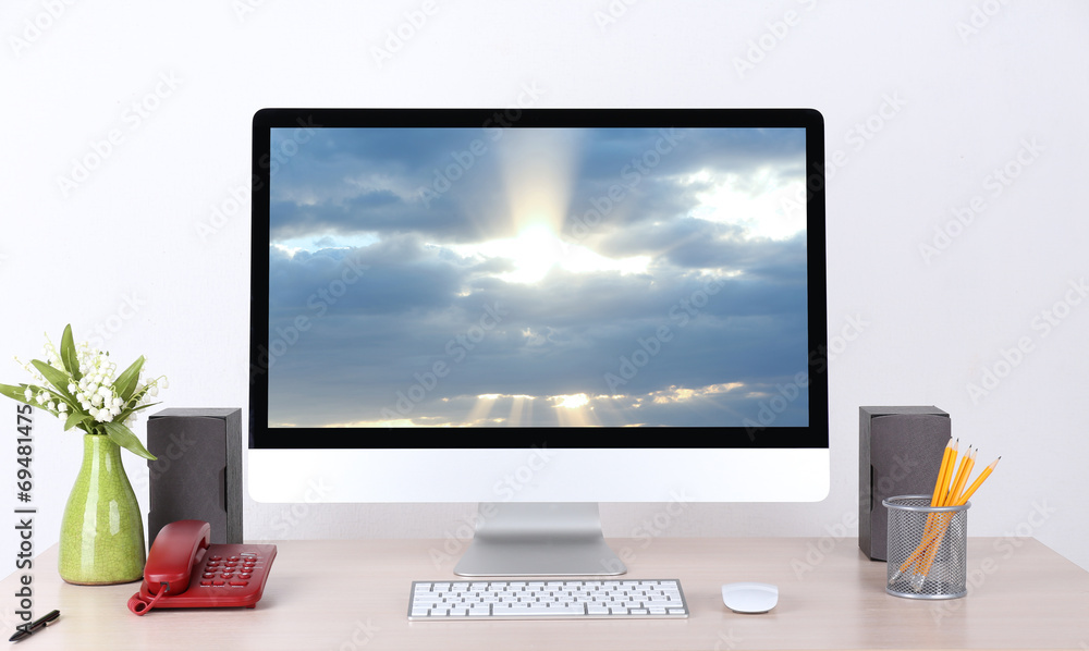 Fototapeta premium Computer with screensaver on table