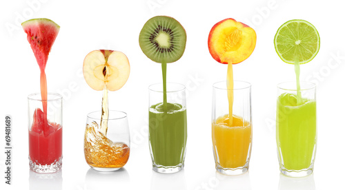 Juice pouring from fruits into glass, isolated on white