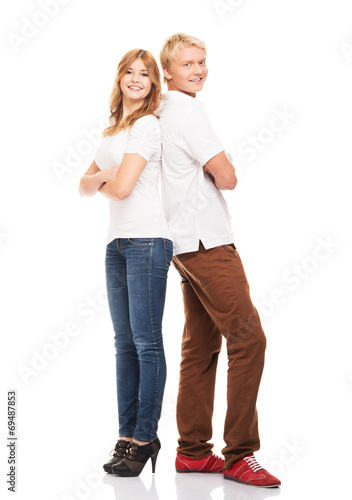 Stylish teenage couple standing isolated on white