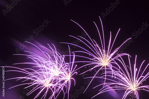 Wonderful purple fireworks shining stars black night background