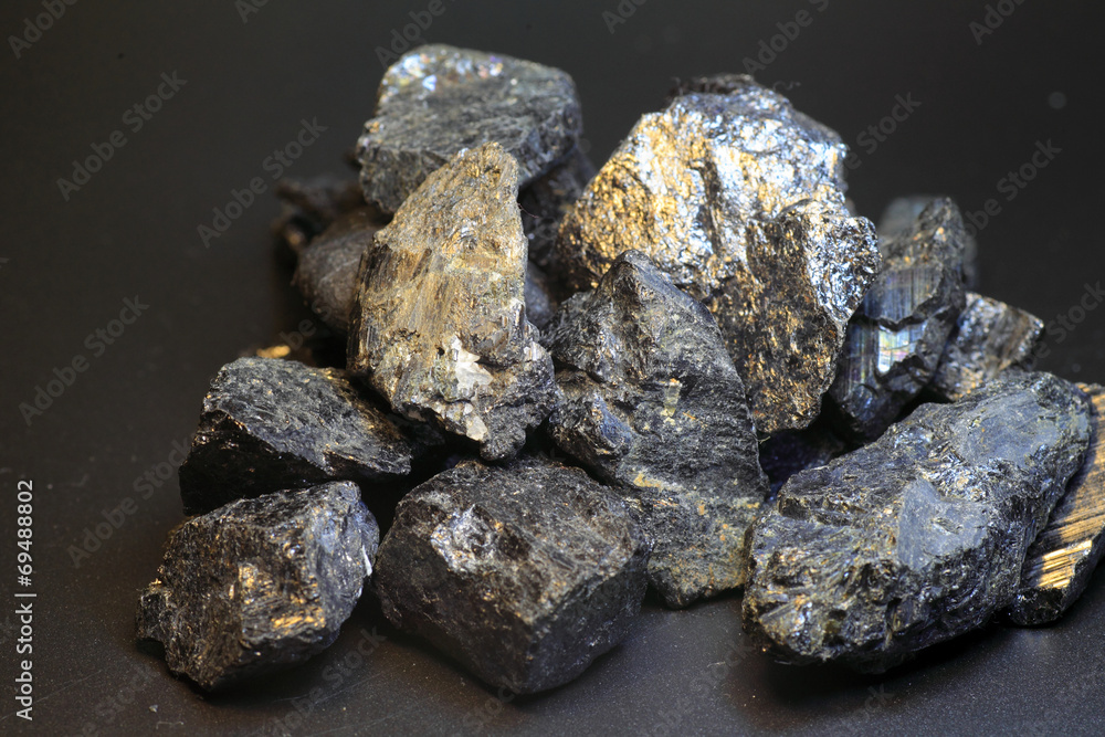 Black tourmaline an aquamarine crystal in front of black Black tourmaline an aquamarine crystal in front of black