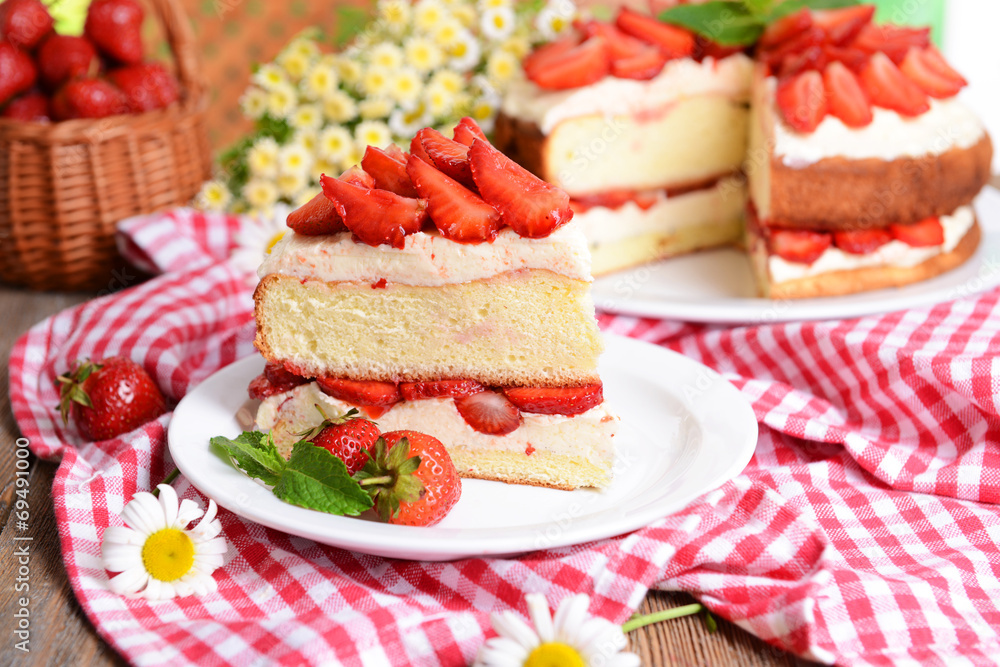 Delicious biscuit cake with strawberries on table close-up Delicious biscuit cake with strawberries on table close-up