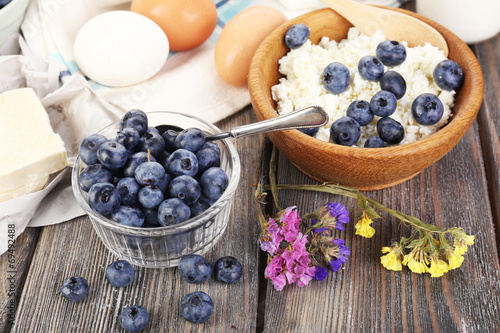 Fresh blueberries and milk products on wooden table