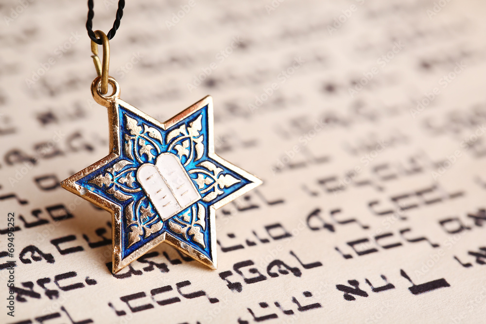 Fototapeta premium Star David pendant on old paper page background