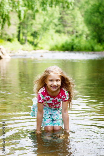 Fototapeta Naklejka Na Ścianę i Meble -  Adorable   girl  in   river on sunny   day