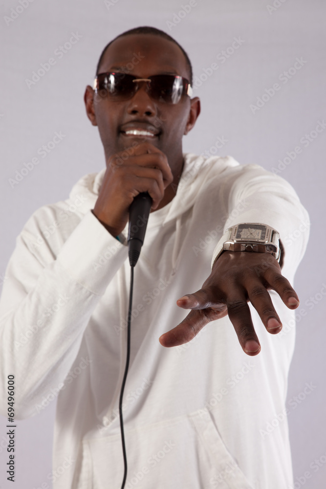 black man singing into a micdrophone