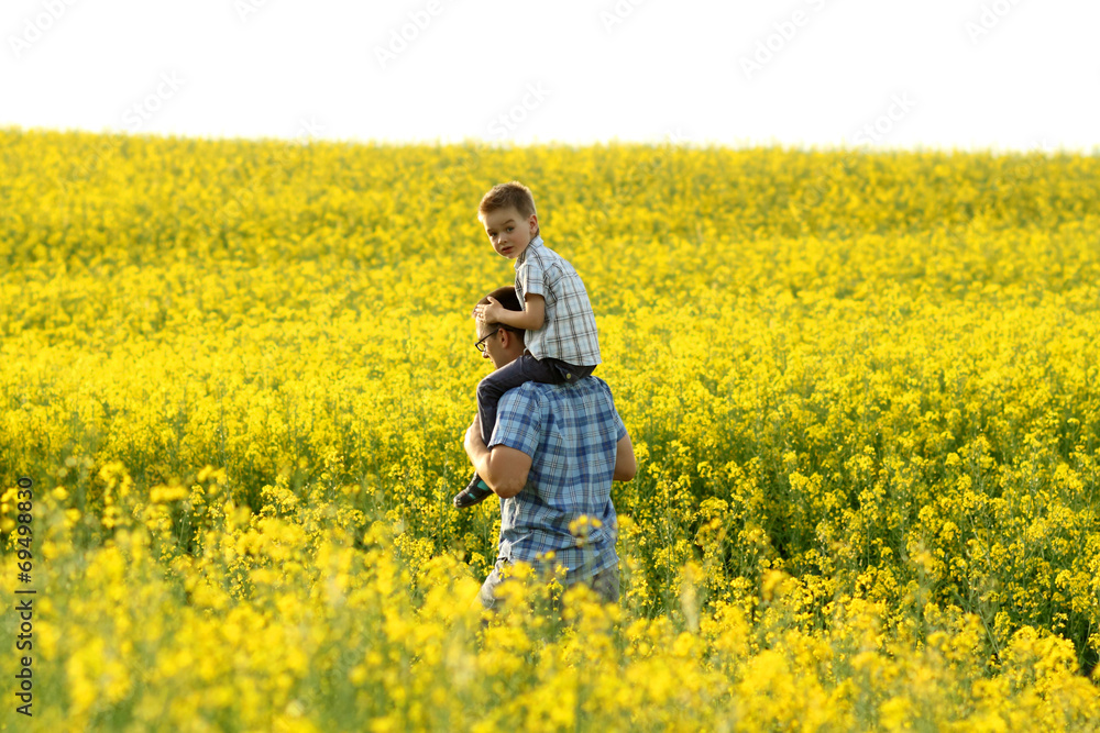 happy family in a field of yellow flowers happy family in a field of yellow flowers
