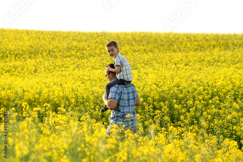 happy family in a field of yellow flowers