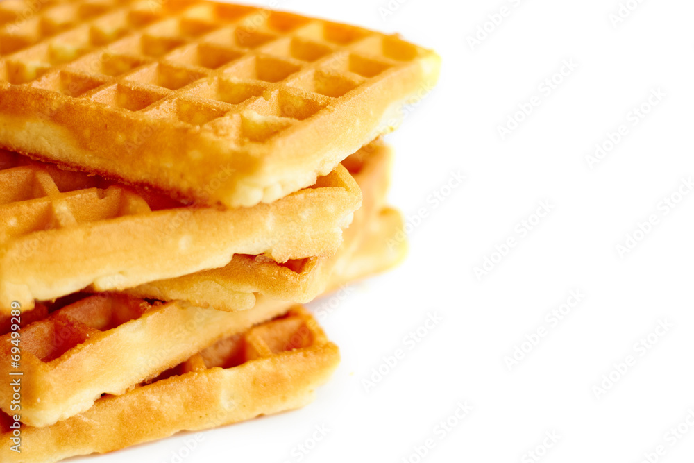 Golden waffles on white background vertical close up view Golden waffles on white background vertical close up view