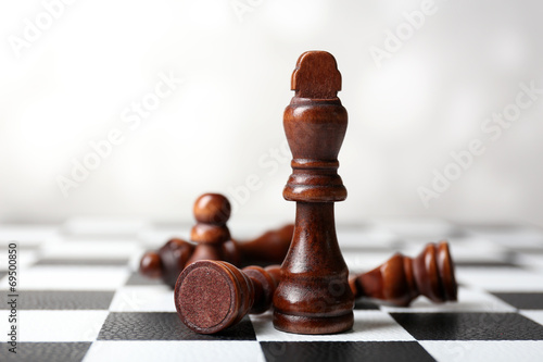 Chess board with chess pieces on grey background