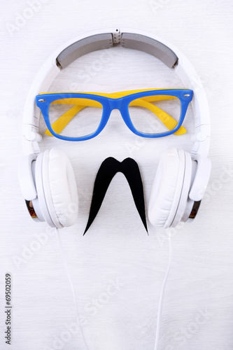 Glasses, mustache and headphone forming man face