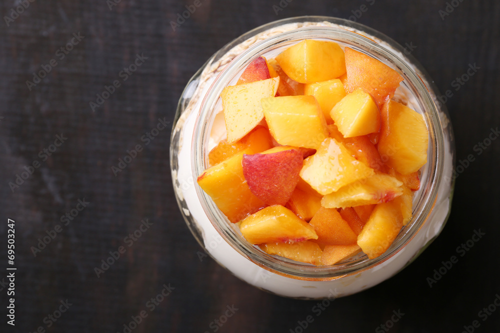 Healthy breakfast - yogurt with fresh peach and muesli served Healthy breakfast - yogurt with fresh peach and muesli served