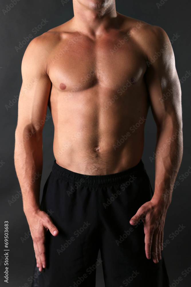 Fototapeta premium Handsome muscle young man on dark background