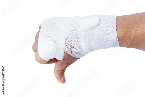Fototapeta Thumb down showing by hand with white bandages isolated