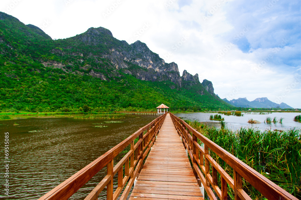 Naklejka premium Wooden Bridge in lake under blue sky , Samroiyod national park,