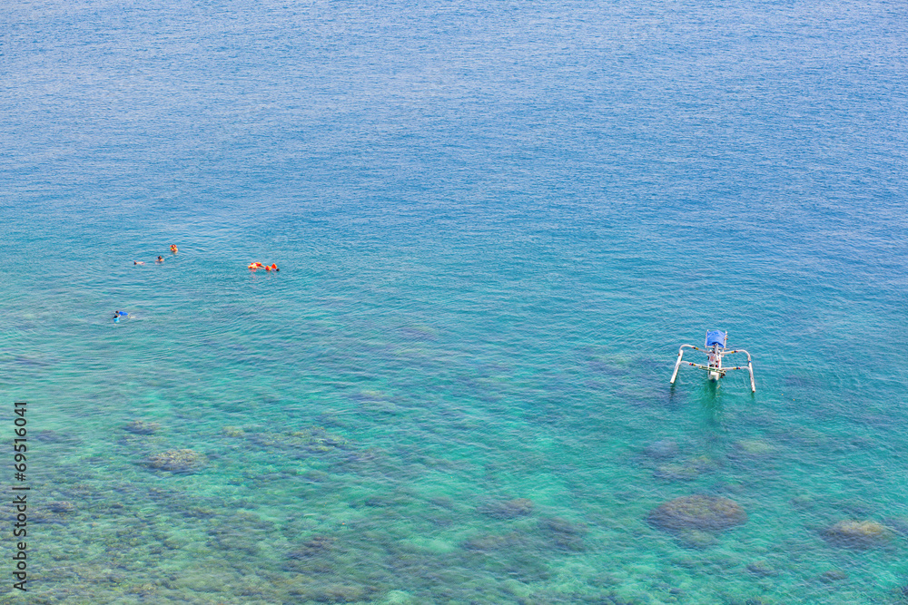 People snorkeling in turquoise water on Bali