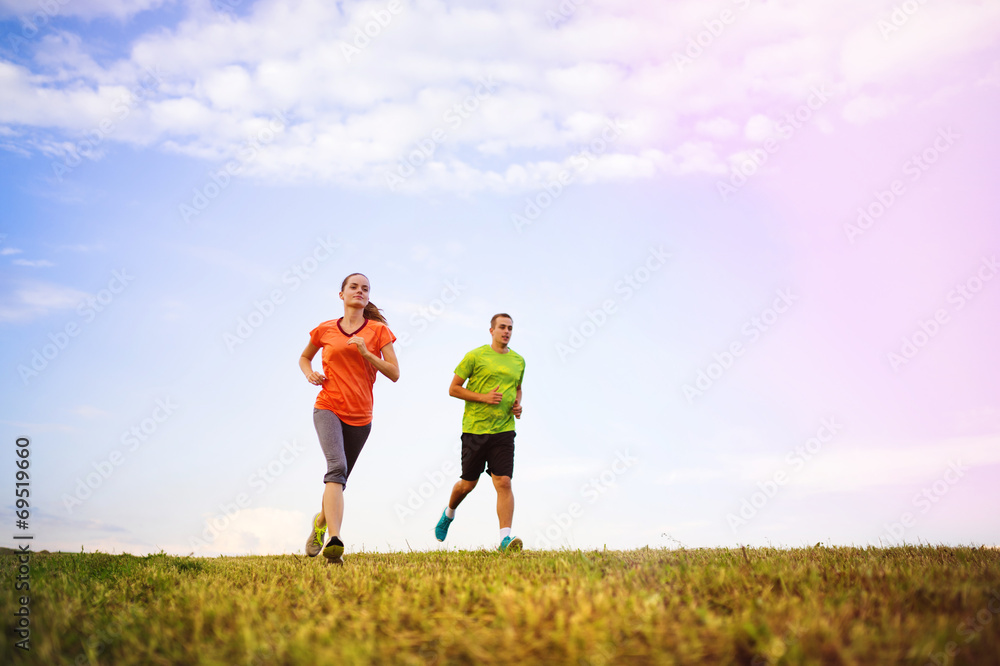 Couple running at sunset