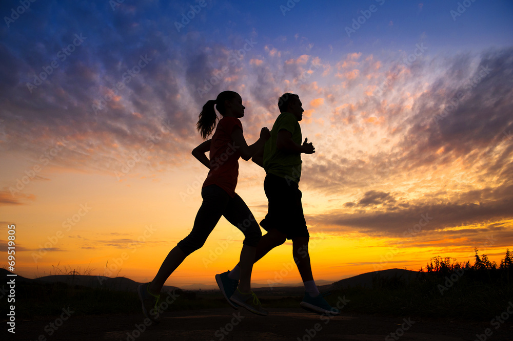 Silhouette of couple running