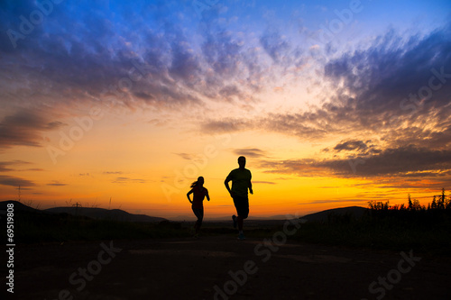 Silhouette of couple running
