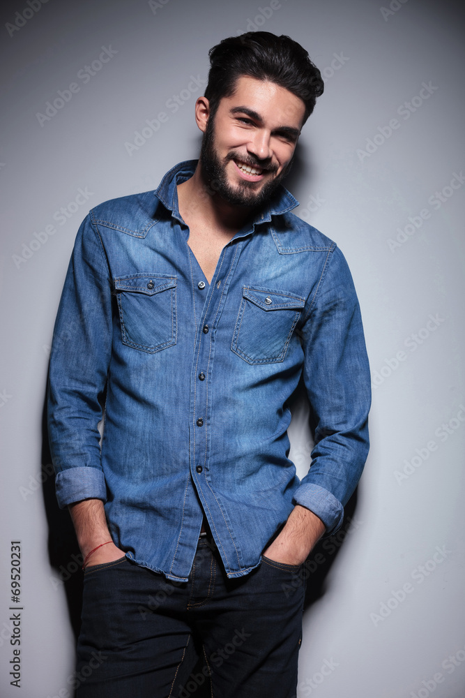 Man smiling with his hands in pocket Man smiling with his hands in pocket