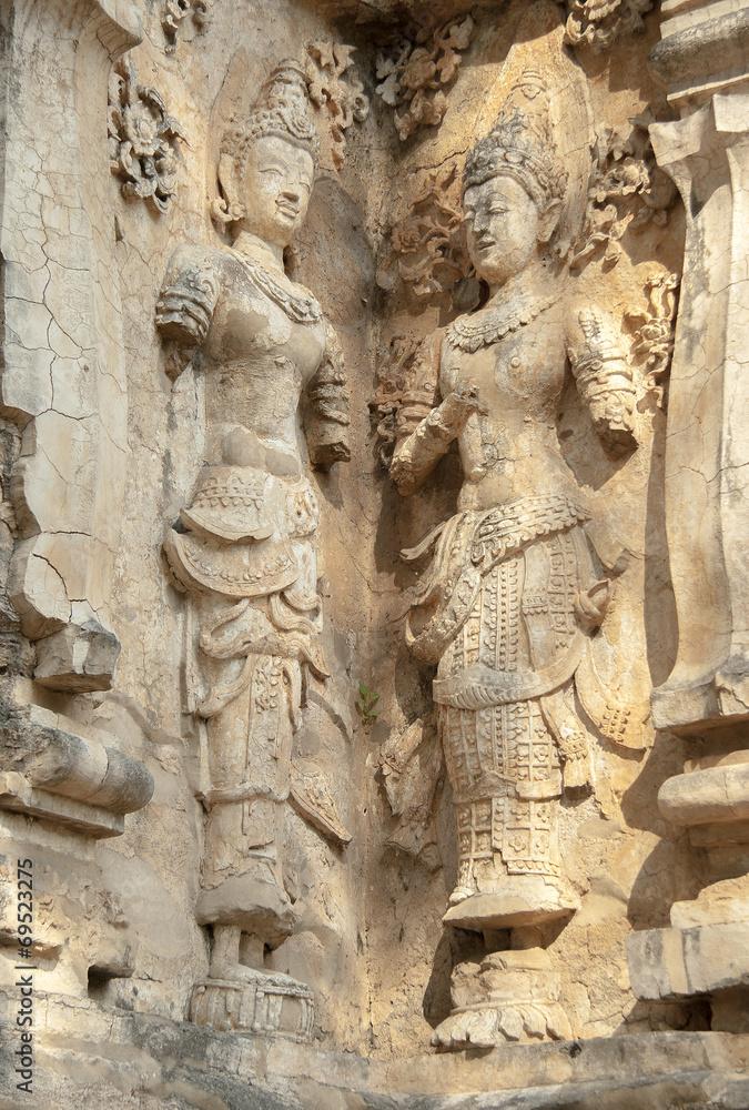 decorated wall with a mythological figure in a Buddhist temple