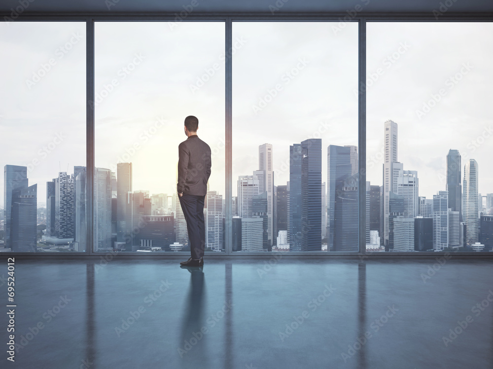 business man looking megalopolis through window business man looking megalopolis through window