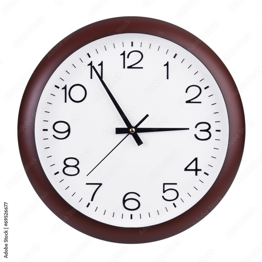 Round clock shows five minutes to three Round clock shows five minutes to three