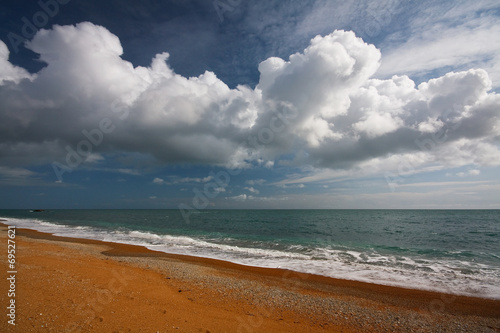 A summer cloudscape on a Jurassic coast beach in Dorset, UK.