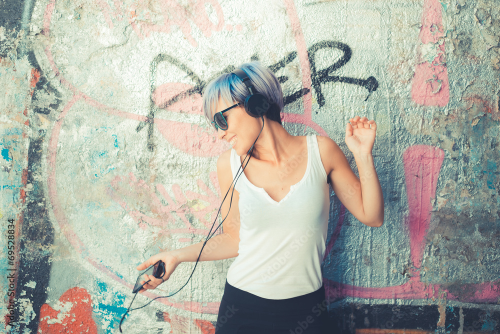 Obraz premium young beautiful short blue hair hipster woman with headphones mu