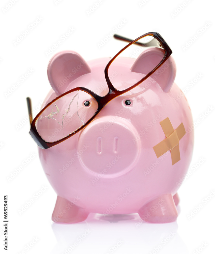 Piggy bank with broken eyeglasses and bandage Piggy bank with broken eyeglasses and bandage