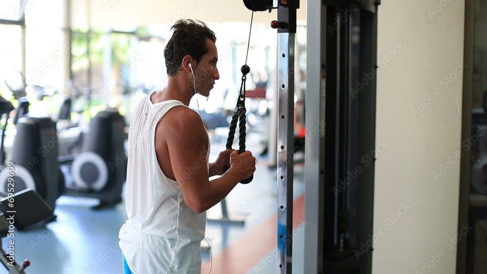 attractive young man exercising in the gym attractive young man exercising in the gym