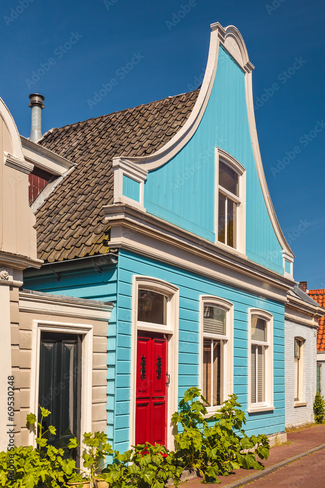 Colorful ancient blue wooden house in The Netherlands Colorful ancient blue wooden house in The Netherlands
