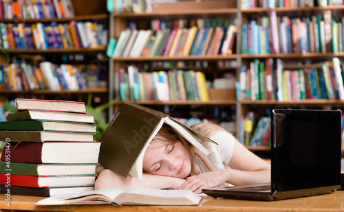 pretty female student sleep in library