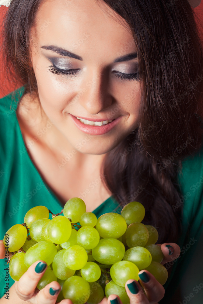 beautiful young woman wearing wreath and holding green grapes ag beautiful young woman wearing wreath and holding green grapes ag