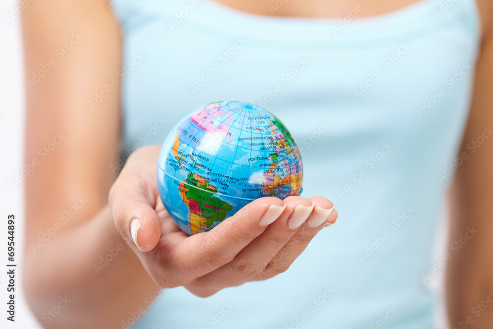 woman's hand with globe woman's hand with globe