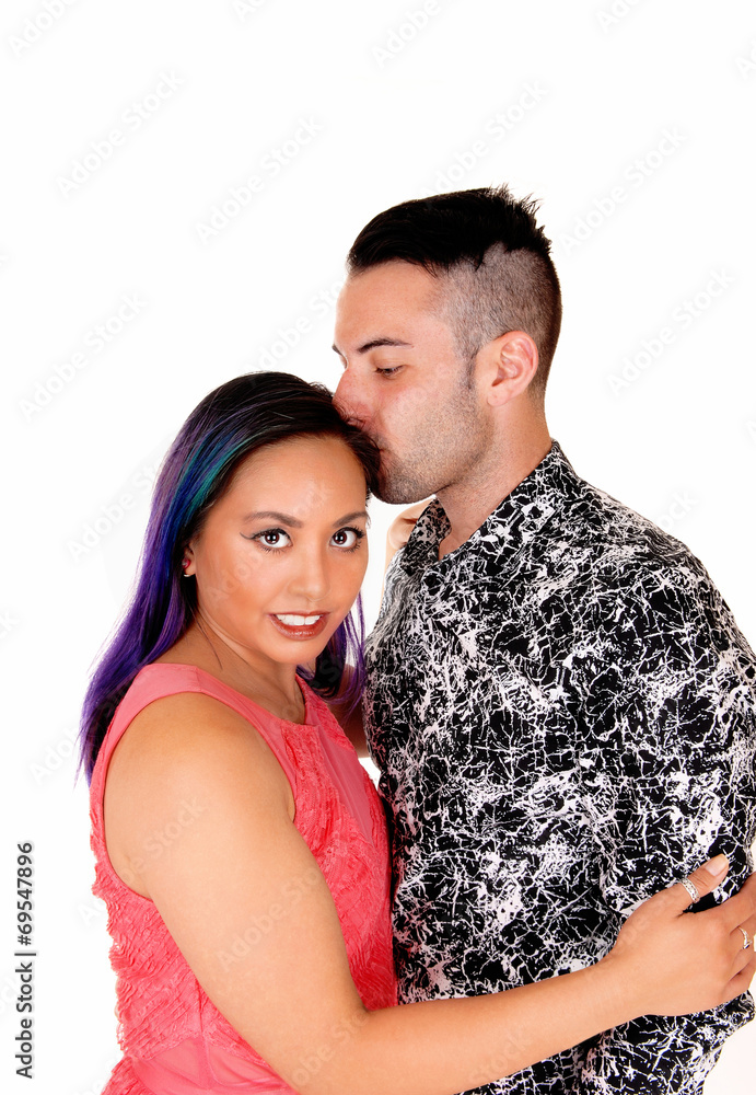 Man kissing girl on head. Man kissing girl on head.