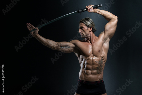 Warrior With Long Sword Over Black Background