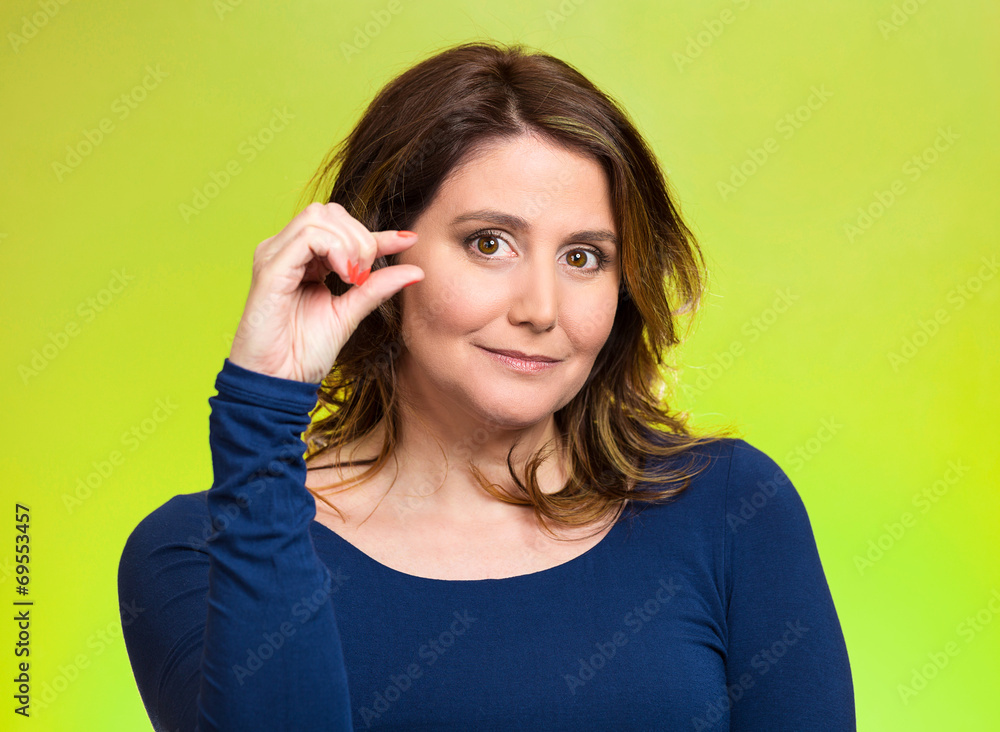Woman, showing small amount gesture with hand Woman, showing small amount gesture with hand