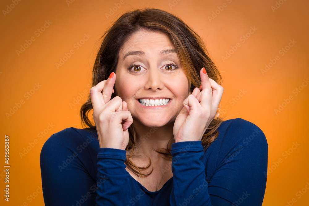 Woman mother crossing her fingers hoping for best Woman mother crossing her fingers hoping for best