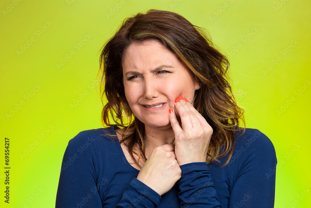 Woman with sensitive tooth ache, on green background Woman with sensitive tooth ache, on green background