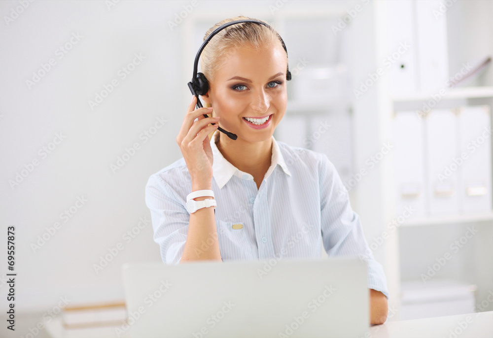 Portrait of beautiful businesswoman working at her desk with he Portrait of beautiful businesswoman working at her desk with he