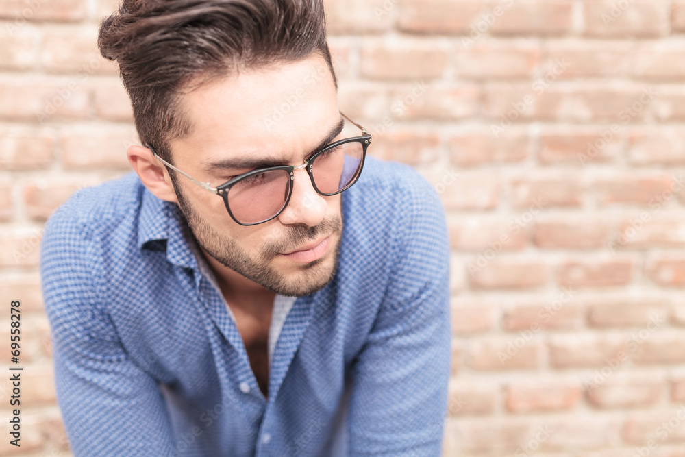 closeup picture of a young casual man with glasses closeup picture of a young casual man with glasses