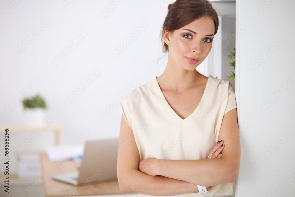 Close-up portrait of a smiling business woman standing in her Close-up portrait of a smiling business woman standing in her