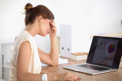 Young and beautiful businesswoman tired from work in the office