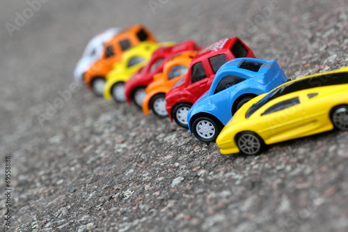 miniature colorful cars standing in line on road sale concept