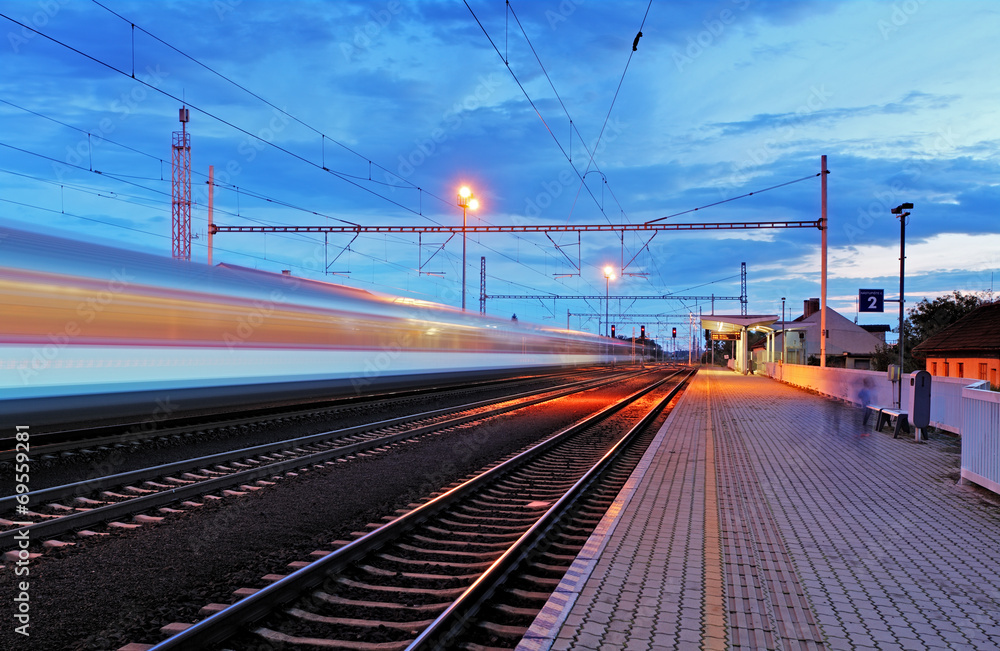 Train station in motion blur at night, railroad