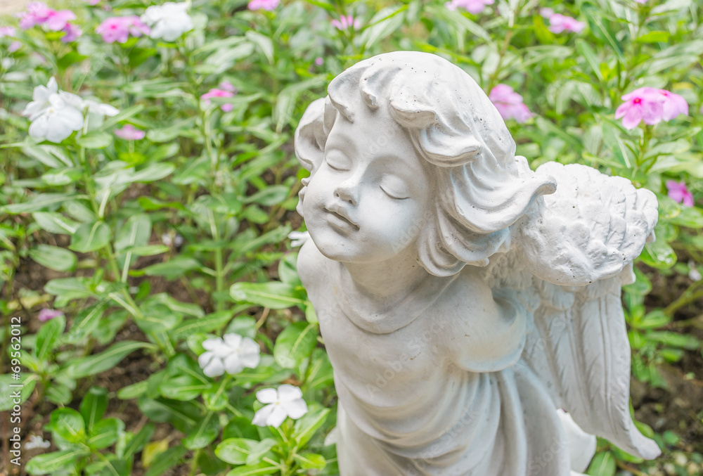 Fairy Statue in the garden with flower Fairy Statue in the garden with flower