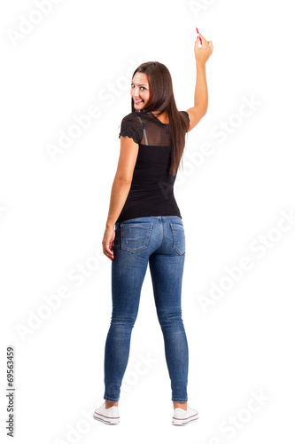 Smiling beautiful brunette pointing with pencil back view
